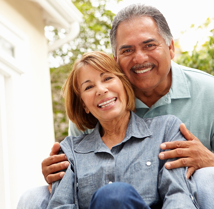 A  smiling senior couple relaxing in a garden