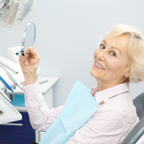 A happy senior woman at a dental clinic