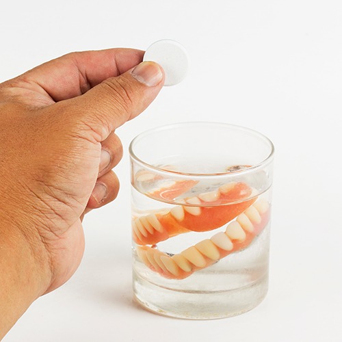 Dentures soaking in a solution