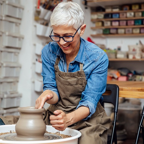 Woman smiling while taking pottery class